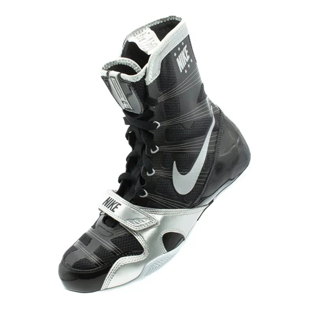 Angled view of the black and silver Nike HyperKO 1 boxing boot showing the Swoosh and forefoot strap