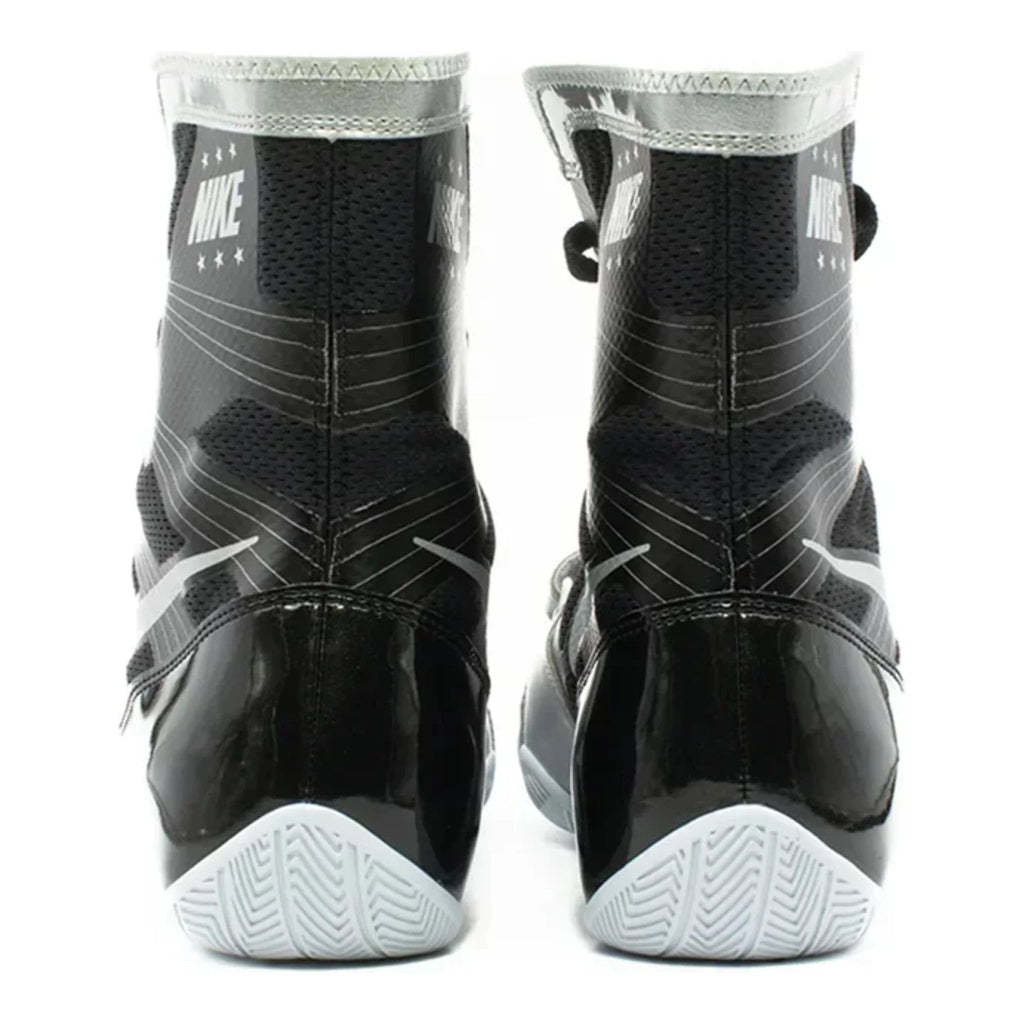 Rear heel view of a pair of black and metallic silver Nike HyperKO 1 boxing boots