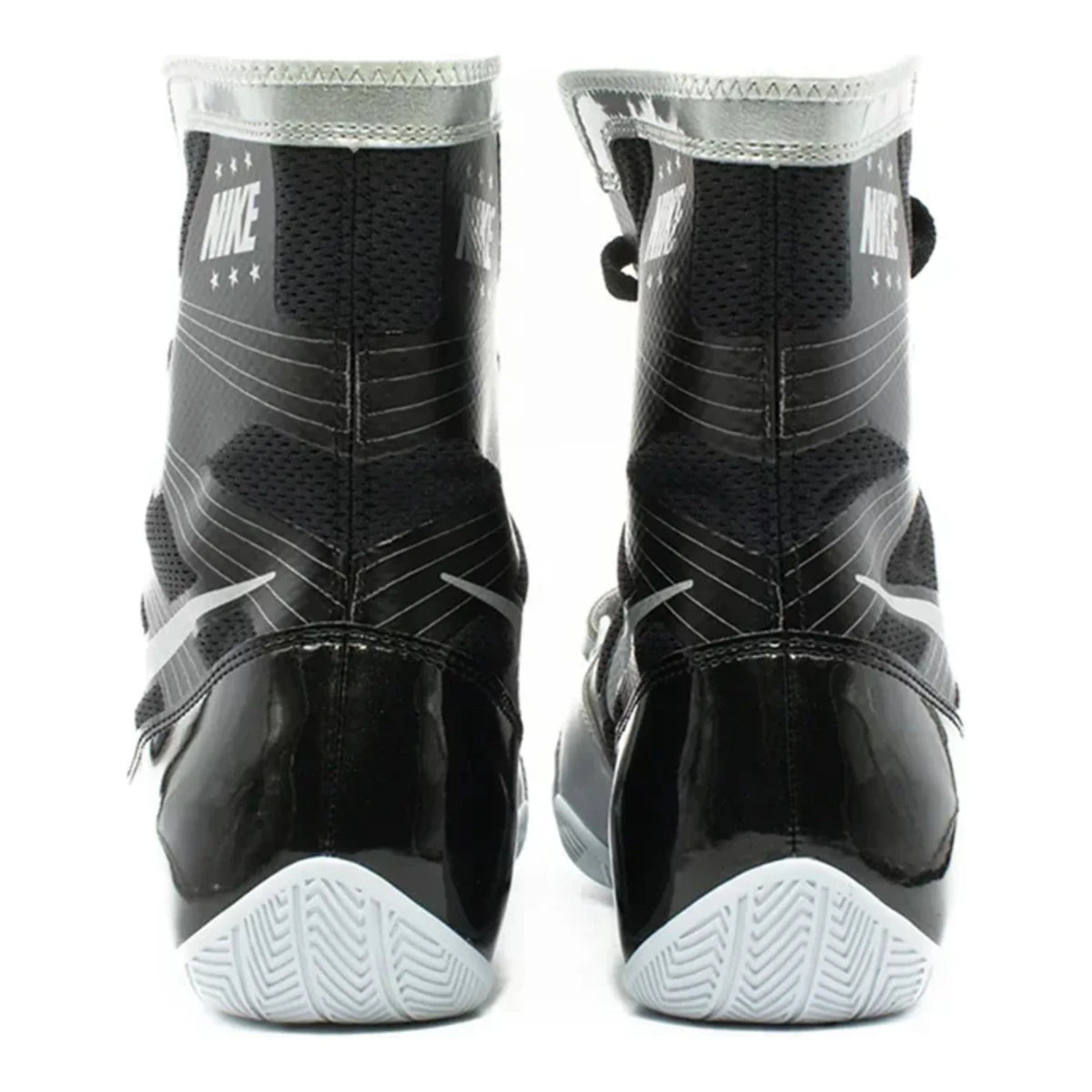 Rear heel view of a pair of black and metallic silver Nike HyperKO 1 boxing boots